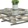 Glass Top Coffee Table with Asymmetrical Metal Base Silver and Clear By Casagear Home AMF-84610