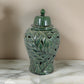 Heni 19 Inch Ceramic Temple Jar with Lid, Cut Out Leaf Motifs, Green Finish By Casagear Home